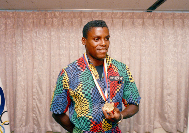 Carl Lewis shows off his 100 meter gold after Ben Johnson was stripped of his medal. Photo: Lennox McLendon/AP Images.
